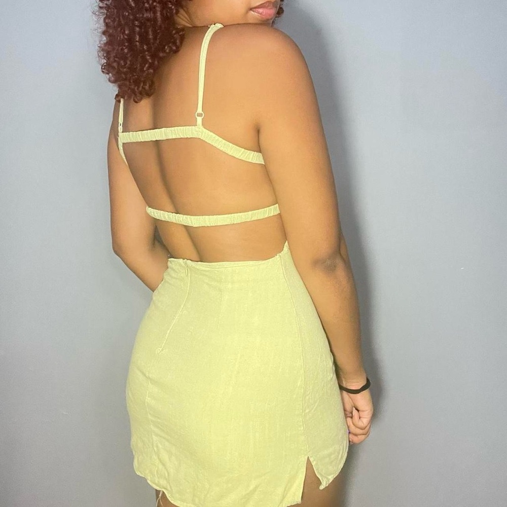 green mini dress with strappy open back